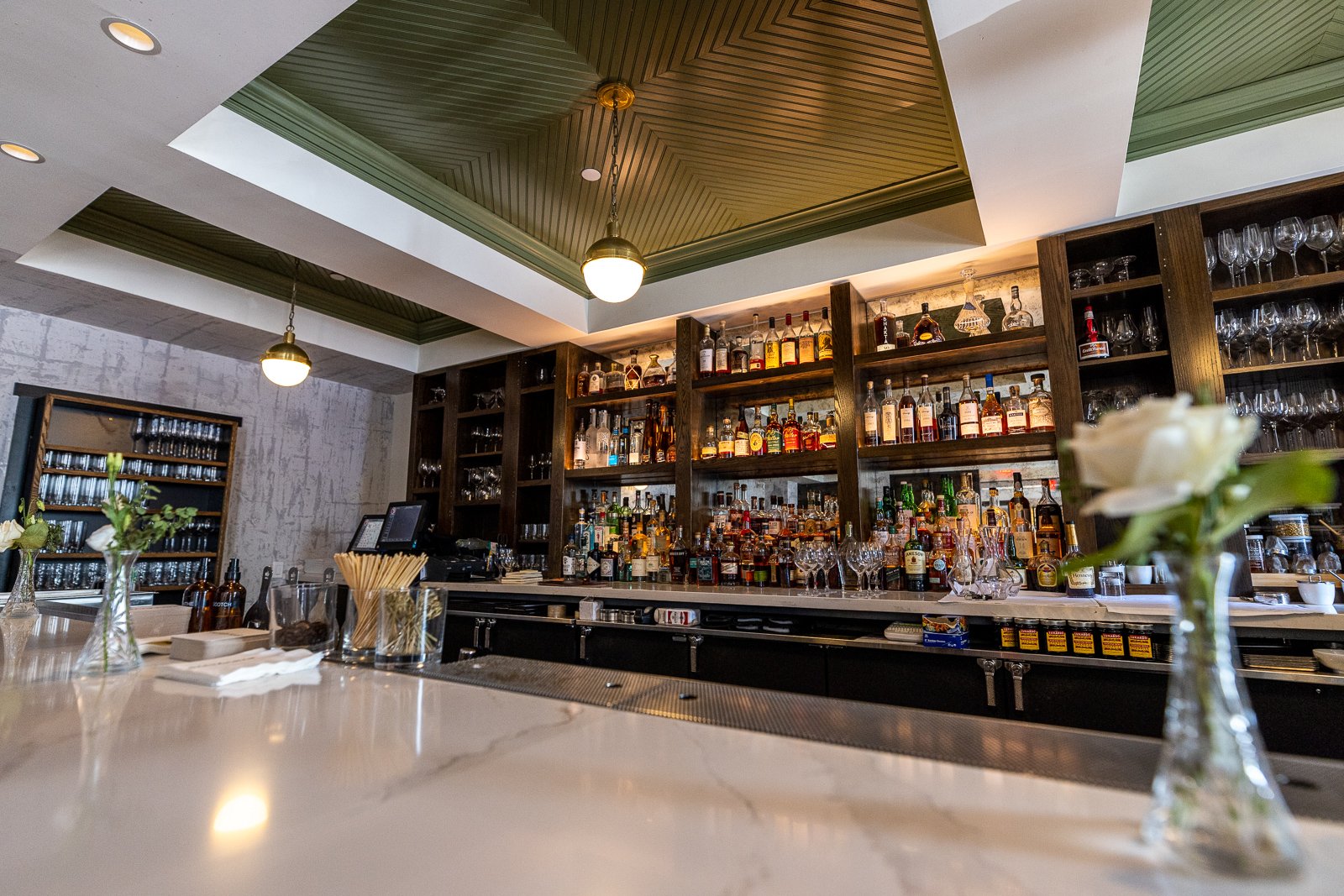 Salt and Char bar with marble counter and back-bar shelving